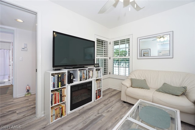 living room with ceiling fan and light wood-type flooring