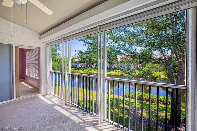 unfurnished sunroom featuring ceiling fan