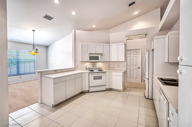 kitchen with pendant lighting, white cabinets, white appliances, and kitchen peninsula