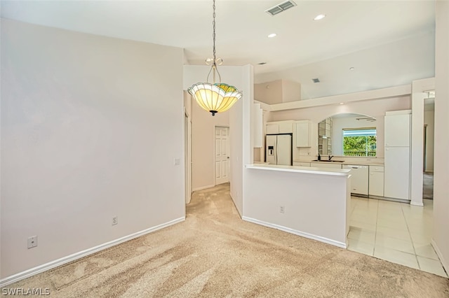 kitchen with white cabinetry, white appliances, light colored carpet, and lofted ceiling