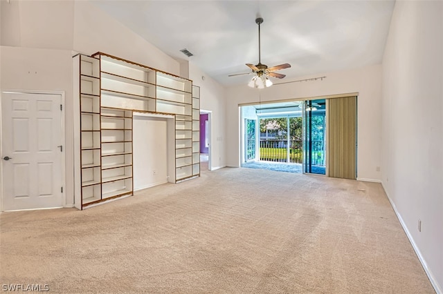 unfurnished living room featuring light carpet, vaulted ceiling, and ceiling fan