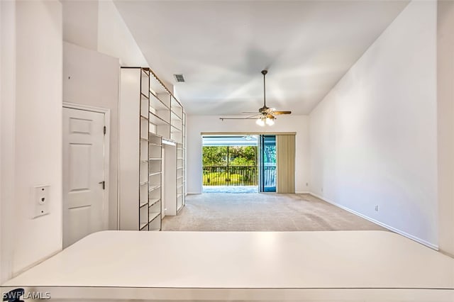 interior space featuring ceiling fan and vaulted ceiling