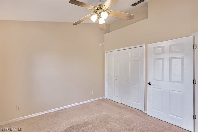 unfurnished bedroom featuring light colored carpet, ceiling fan, and a closet