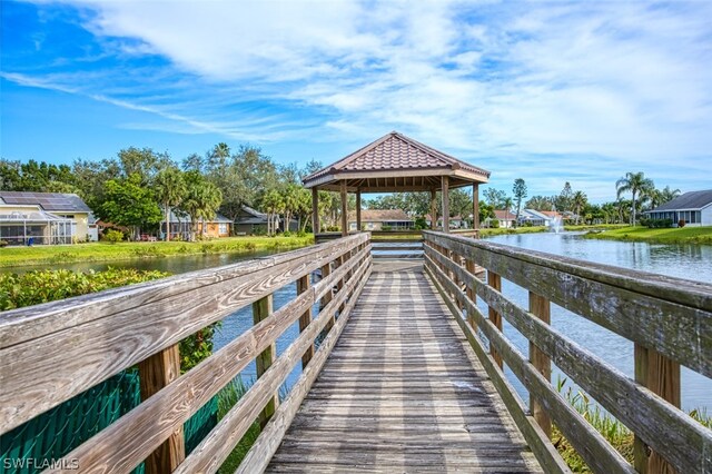 view of dock featuring a gazebo and a water view