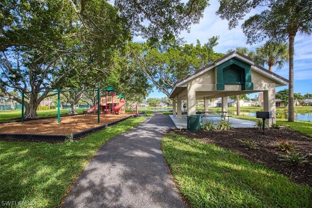 surrounding community featuring a gazebo, a water view, a playground, and a lawn