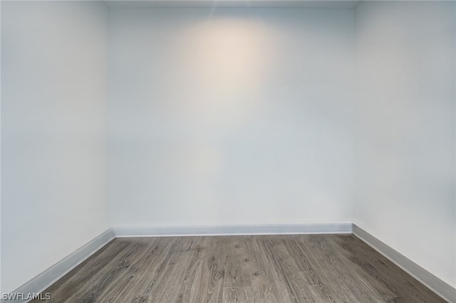 empty room with dark wood-type flooring