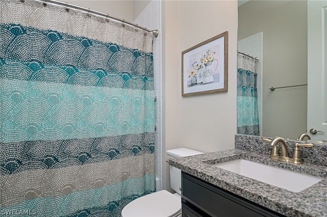 bathroom with vanity, curtained shower, and toilet