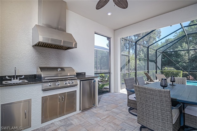 view of patio / terrace with a grill, area for grilling, sink, and glass enclosure