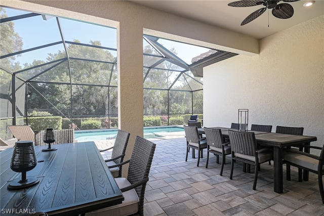 view of patio featuring ceiling fan and a lanai