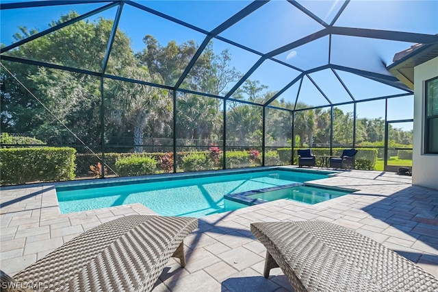 view of swimming pool featuring a patio area and a lanai