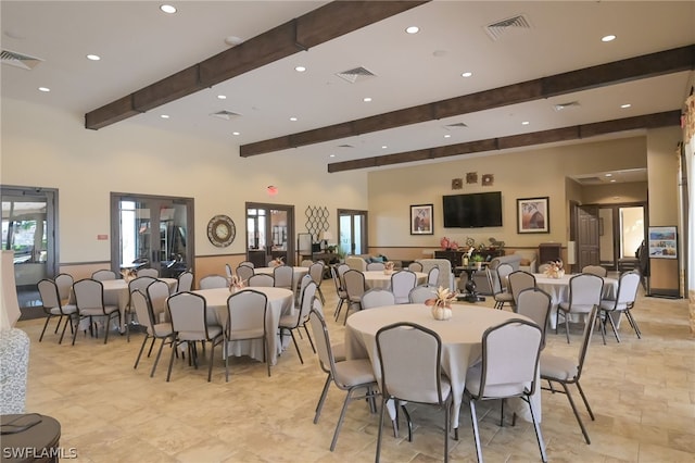 dining area featuring beamed ceiling