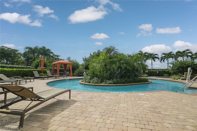 view of swimming pool with a gazebo and a patio