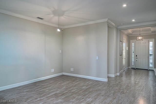 foyer entrance with hardwood / wood-style flooring and ornamental molding