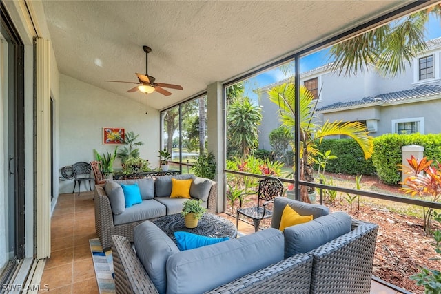 sunroom featuring vaulted ceiling and ceiling fan