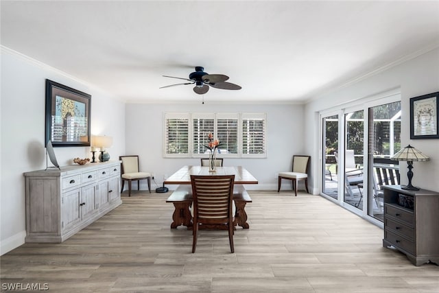 dining space featuring ornamental molding, ceiling fan, and light hardwood / wood-style flooring