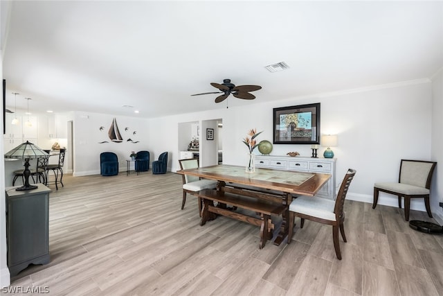 dining area with ornamental molding, light hardwood / wood-style flooring, and ceiling fan