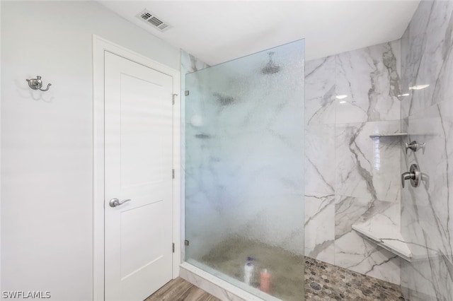 bathroom with hardwood / wood-style floors and walk in shower