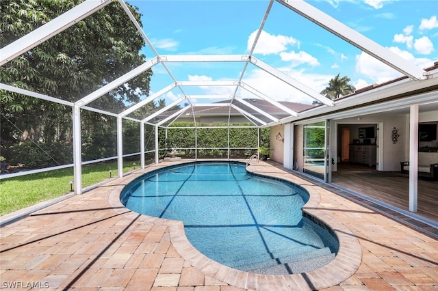 view of pool featuring a lanai and a patio