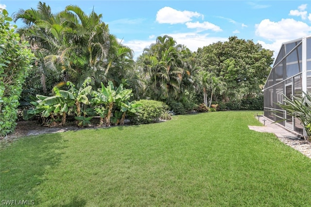 view of yard featuring glass enclosure