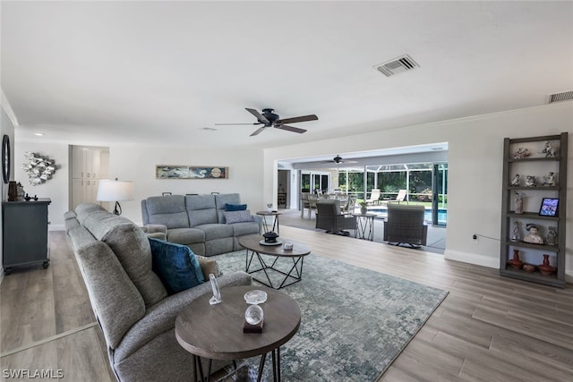 living room with ceiling fan and light wood-type flooring