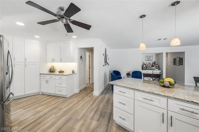 kitchen with pendant lighting, light hardwood / wood-style flooring, white cabinetry, stainless steel fridge, and ceiling fan