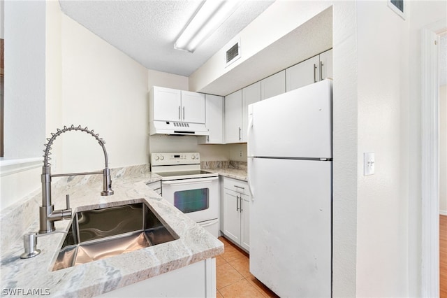 kitchen featuring a textured ceiling, white cabinetry, white appliances, and sink