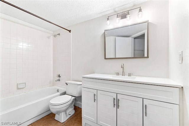 full bathroom featuring tile patterned flooring, a textured ceiling, toilet, vanity, and tiled shower / bath