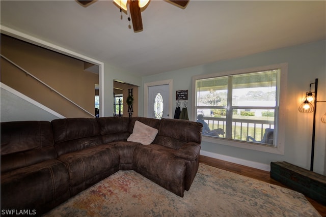 living room featuring wood-type flooring and ceiling fan