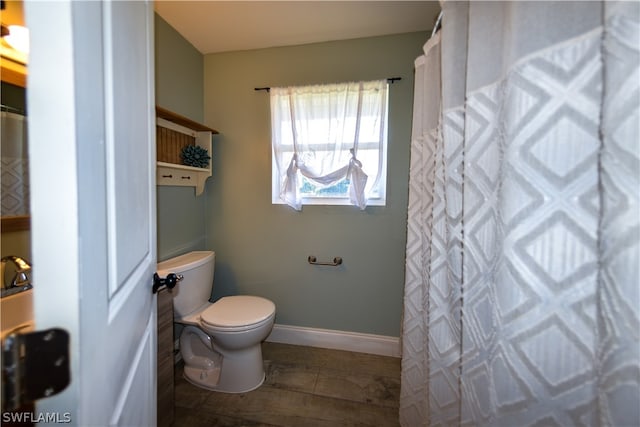 bathroom with hardwood / wood-style flooring and toilet