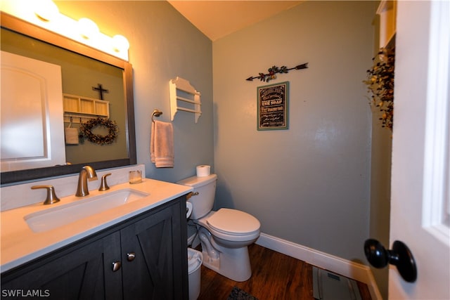 bathroom featuring hardwood / wood-style flooring, toilet, and vanity