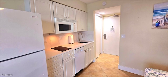 kitchen with white appliances, ceiling fan, sink, white cabinetry, and light tile patterned flooring