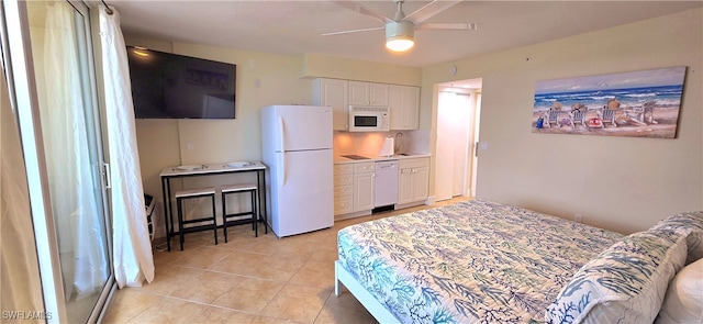 tiled bedroom featuring ceiling fan, sink, and white fridge