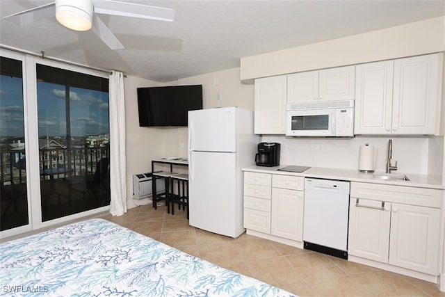 kitchen with white appliances, sink, ceiling fan, light tile patterned flooring, and white cabinetry