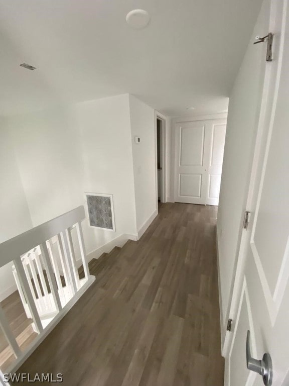 hallway with dark hardwood / wood-style flooring