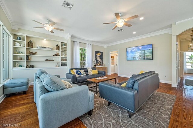 living room with ceiling fan with notable chandelier, dark hardwood / wood-style flooring, and a wealth of natural light