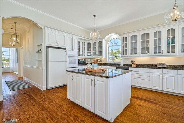 kitchen with pendant lighting, white appliances, and a wealth of natural light