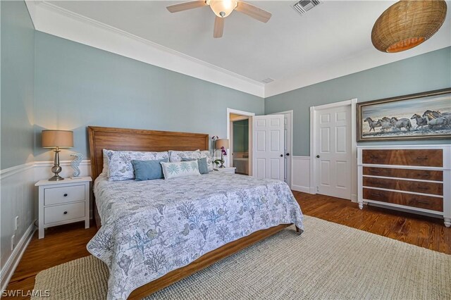 bedroom featuring ceiling fan, crown molding, and dark wood-type flooring