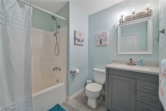 full bathroom with vanity, wood-type flooring, shower / tub combo, and toilet