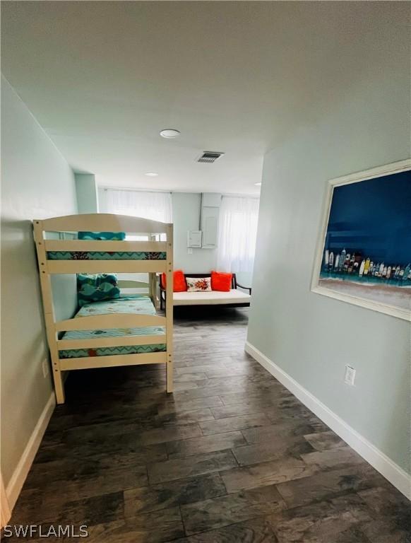 bedroom with dark hardwood / wood-style flooring