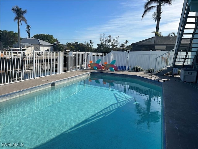 view of swimming pool featuring a water view