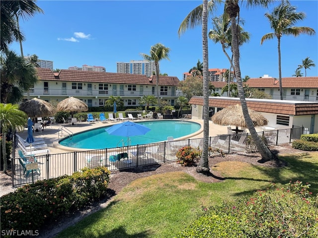 view of pool featuring a lawn