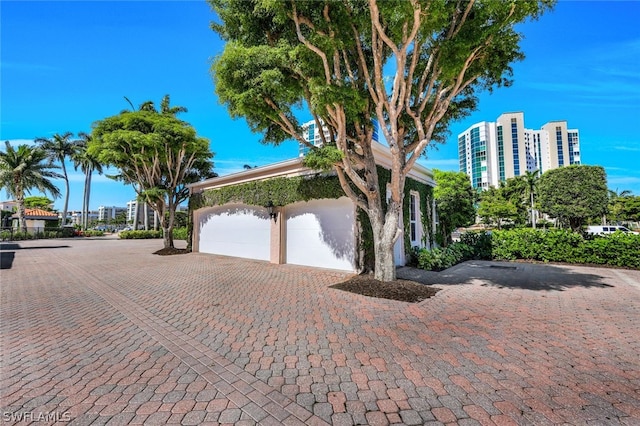 view of front of house featuring an attached garage and decorative driveway