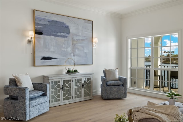 sitting room with crown molding and wood finished floors