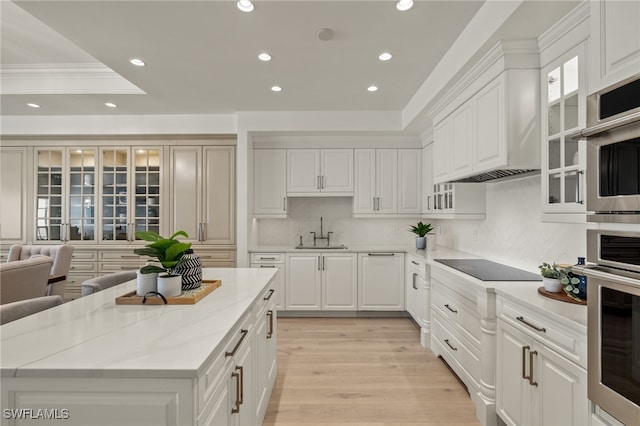 kitchen featuring stainless steel oven, recessed lighting, a sink, and black electric cooktop