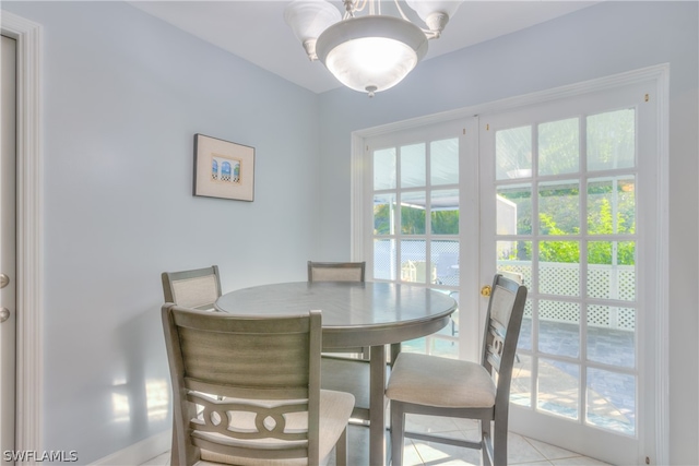 tiled dining space with a chandelier