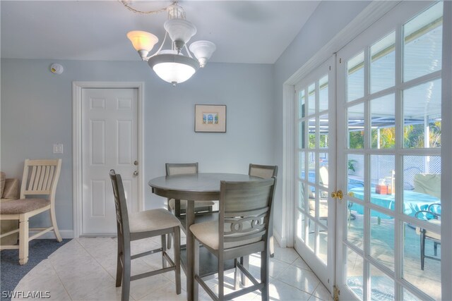 tiled dining area with a notable chandelier