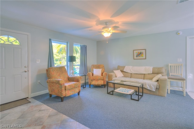 tiled living room with ceiling fan and a healthy amount of sunlight