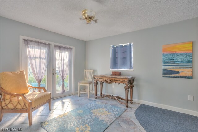 tiled home office with french doors and a textured ceiling