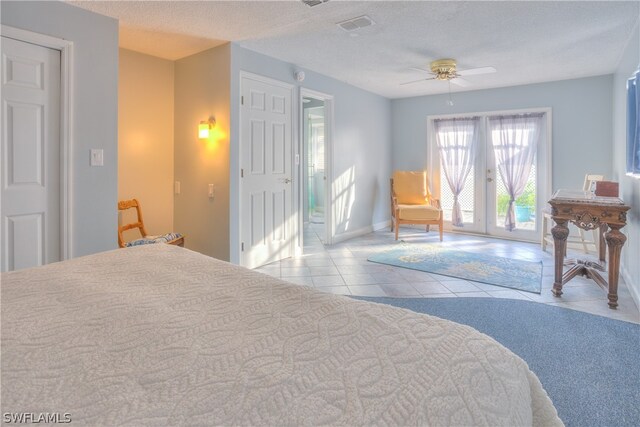 carpeted bedroom featuring french doors, ceiling fan, access to exterior, and a textured ceiling