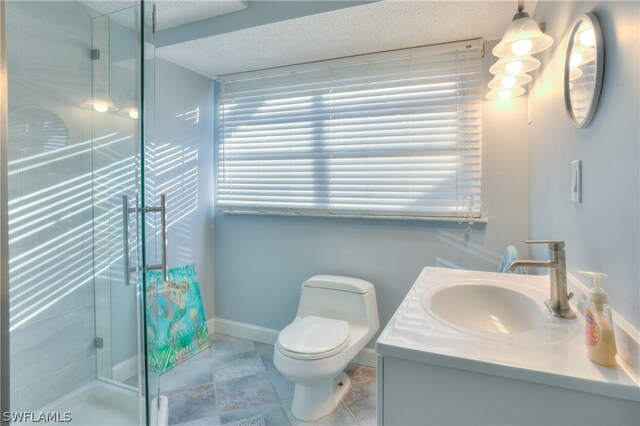 bathroom with a textured ceiling, tile floors, toilet, vanity, and a shower with door